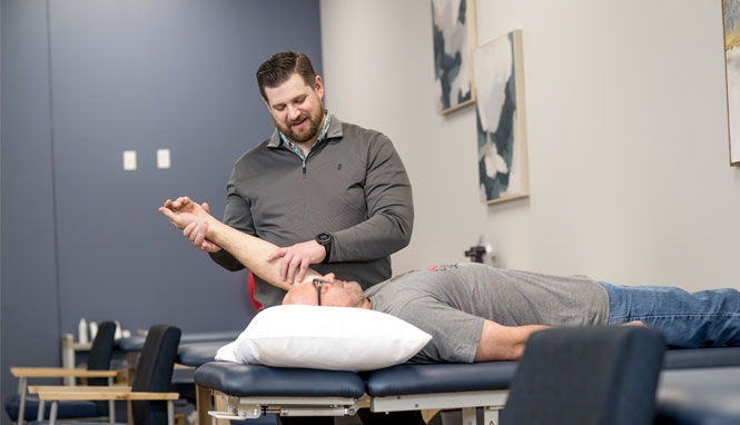 Drew helping a patient stretch